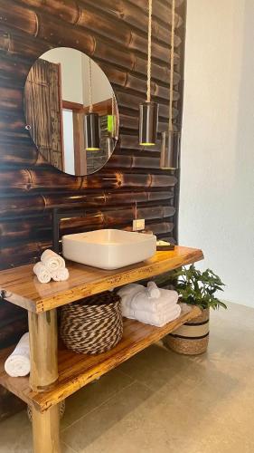 a bathroom with a sink and a mirror at Wild Wasi - Private Jungle Villa in Puyo