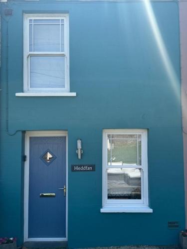 a blue house with a blue door and a window at Llansteffan 2-Bed Cottage Sleeps 4 Dog Ok in Carmarthen