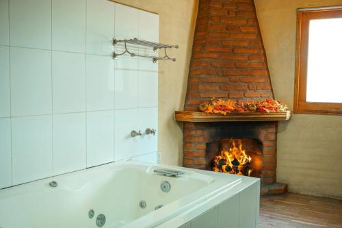 a bath tub in a bathroom with a fireplace at Vistas NO 5 in Mazamitla