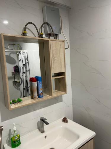 a bathroom with a sink and a medicine cabinet at Nyvin Haven at The Loftel in Ruaka