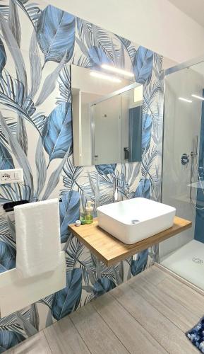 a bathroom with a sink and a mirror at Sienda Cesira in Muravera