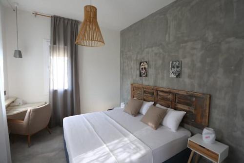 a bedroom with a large white bed and a desk at Villa Paradiso Batroun in Batroûn
