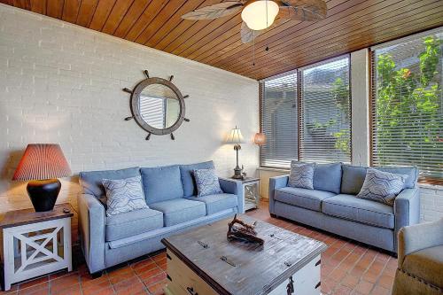 a living room with two blue couches and a table at Beachhead Unit 5 BH5 in Port Aransas