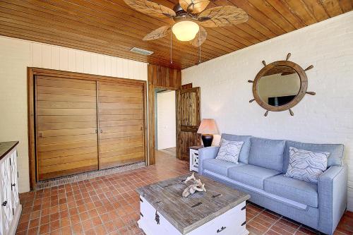 a living room with a blue couch and a table at Beachhead Unit 5 BH5 in Port Aransas
