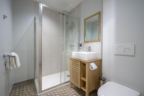 a bathroom with a shower and a sink and a toilet at Domaine du Béron - Chateau et gites in Cappelle-en-Pévèle