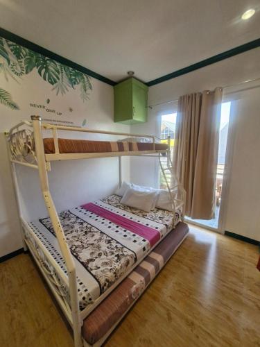 a bedroom with a bunk bed in a room at Aquatico Royalle Private Resort in Calamba