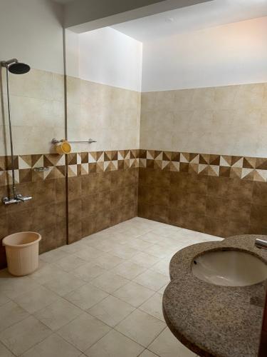 a bathroom with a sink and a shower at Hillside Cottages, Kala Bagh in Nathia Gali