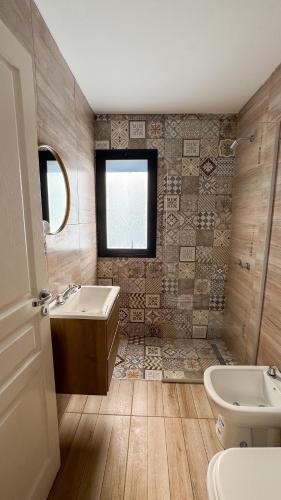 a bathroom with a sink and a tub and a toilet at Aires de Laguna in Chascomús