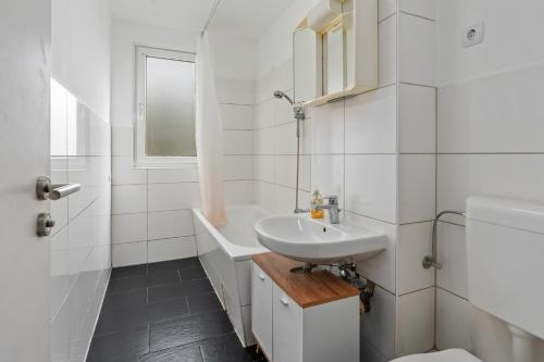 a white bathroom with a sink and a toilet at MK Apartment Delmenhorst nähe Bremen 21 in Delmenhorst