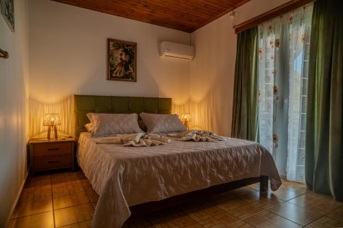 a bedroom with a bed and a window at Sofia's Sea View House in Ágios Dimítrios