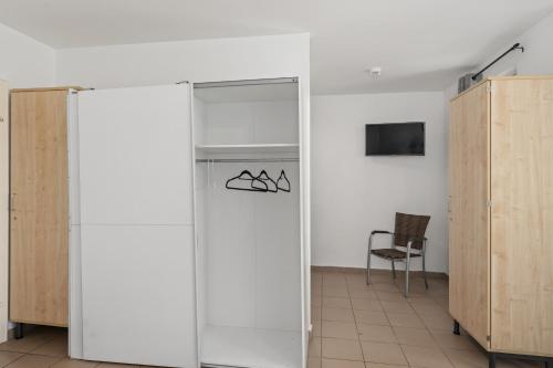 a sliding glass door in a room with a chair at MK Apartments Delmenhorst nähe Bremen 20 in Delmenhorst