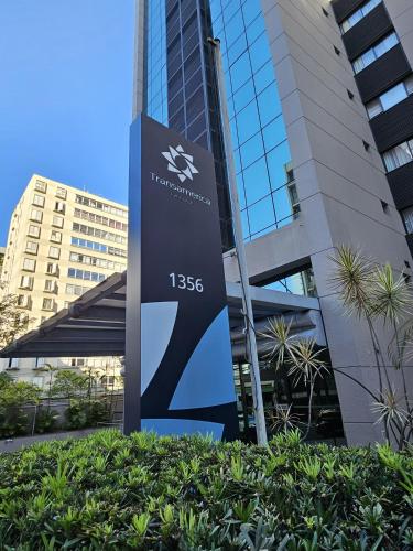 a sign in front of a tall building at Transamerica Executive Bela Cintra (Paulista) in São Paulo