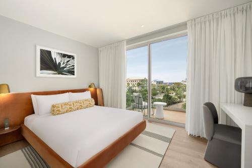 a hotel room with a bed and a large window at ONE GT Grand Cayman in George Town