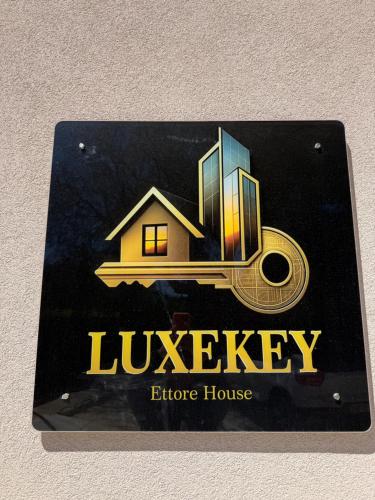 a sign on a wall with a house at Luxekey ETTORE HOUSE in Scopello