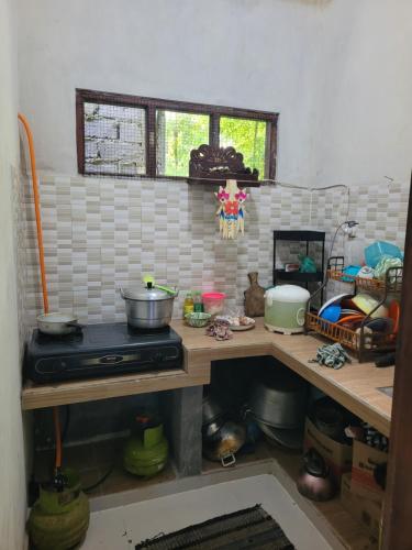 a kitchen with a counter top with a stove at The Sinta Bali in Munduk