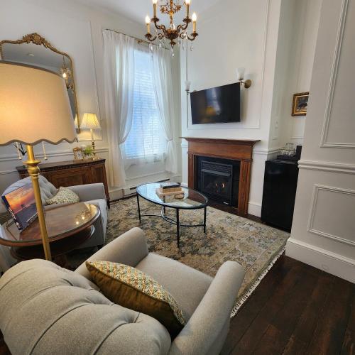a living room with a couch and a fireplace at The Mason Cottage Downtown in Cape May