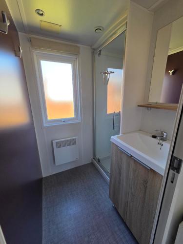 a bathroom with a sink and a window at Nivå Camping & Glamping in Nivå