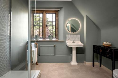 a bathroom with a sink and a mirror at Whistler Rooms in Peterborough