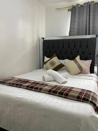 a bed with two towels and pillows on it at Suki Ruaka Homes in Ruaka