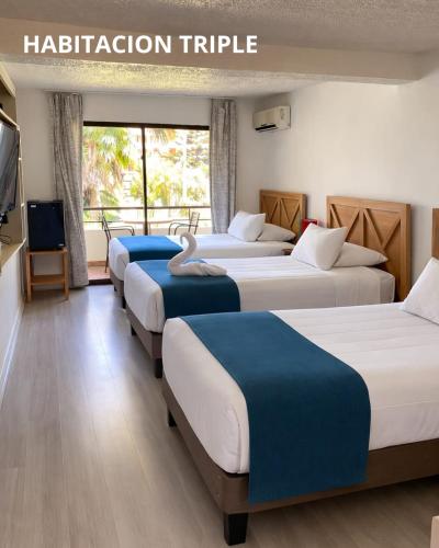 a row of beds in a hotel room at Hotel Palmas de La Serena in La Serena
