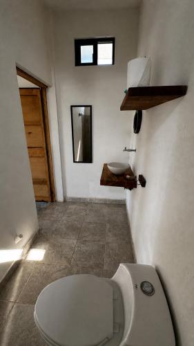 a bathroom with a toilet and a sink at Casa Arena, Zipolite Playa del Amor in Zipolite