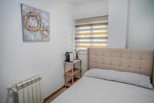 a bedroom with a bed and a window at Hostale Blas Cabrera Madrid in Madrid