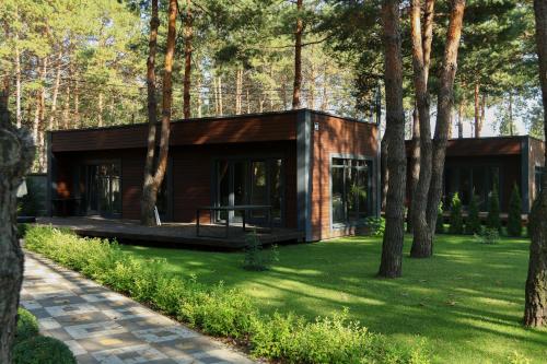 a house in the middle of a field with trees at Grace Place in Soshnikov