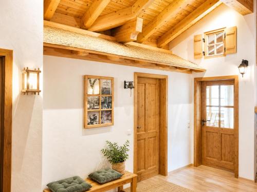 a hallway with wooden ceilings and a wooden door at AlpStern Ferienwohnungen Oberstdorf in Oberstdorf