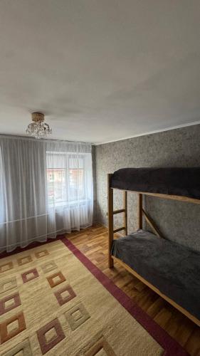 a bedroom with two bunk beds and a window at Хостел in Sumy