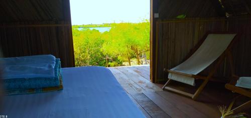 a bedroom with a bed and a window with a view at Caban Zenfants in Sainte Marie
