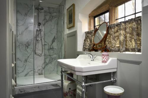 a bathroom with a sink and a shower at Morland Manor in Peterborough