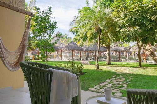 a view from the balcony of a resort with a hammock at Iberostar Selection Playa Mita - All Inclusive in Punta Mita