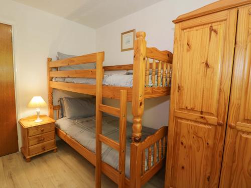 a bedroom with two bunk beds in a room at Trem Y Foel in Penrhyndeudreath