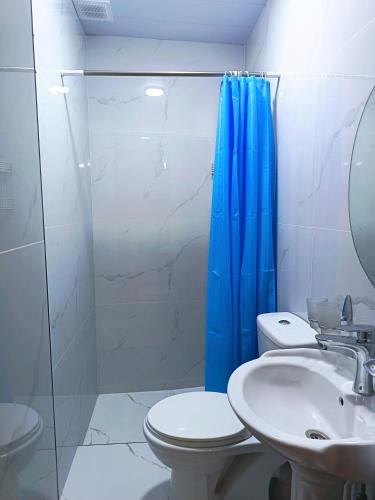a bathroom with a toilet and a sink and a shower at Hotel Nazira & Azizbek in Bukhara