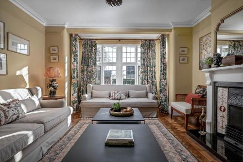 a living room with a couch and a fireplace at Greenwood Manor in Peterborough