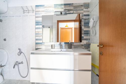 a bathroom with a sink and a mirror at Fiordaliso in Alba Adriatica