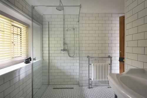a bathroom with a shower and a sink at Home Farm Cottage in Peterborough