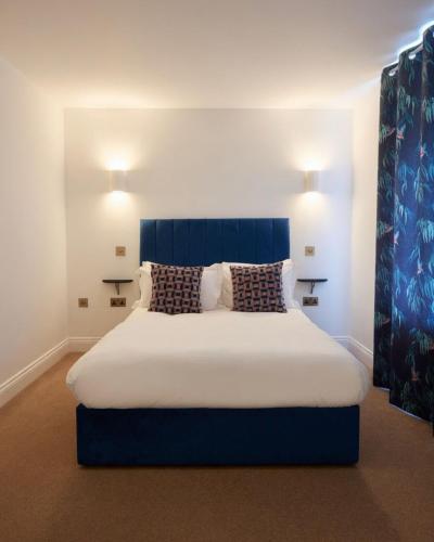 a bedroom with a large bed with two pillows at The Hairy Lemon in Alnwick