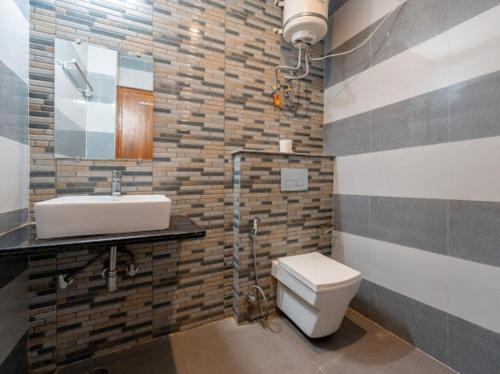 a bathroom with a toilet and a sink at Boho Stays Rishikesh in Rishīkesh