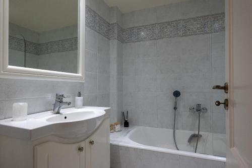 a bathroom with a sink and a bath tub at MAREL Luxury Residence Malia in Malia