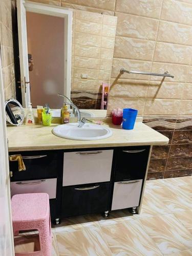 a bathroom counter with a sink and a mirror at Chatet on Casabinca NorthCoast in Dawwār Abū Maḩrūs