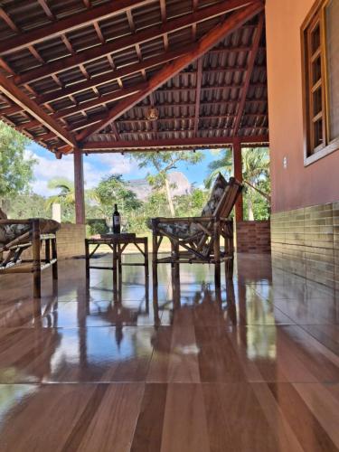 a dining room with a table and chairs in a house at Cottage Saint Antoine in Pedra Azul
