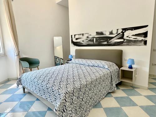 a bedroom with a bed and a picture on the wall at Capraia,Elba in San Vincenzo