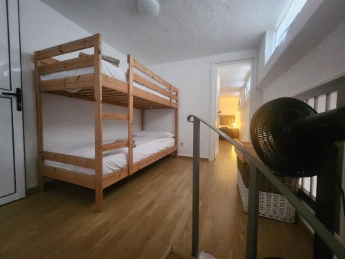 a room with two bunk beds and a fan at Sunset Balcony with Ocean Views and pool access in Mogán