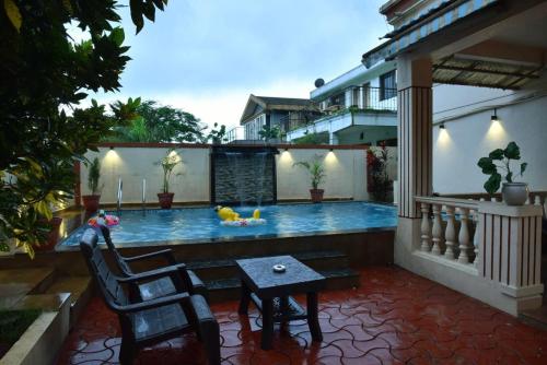 a swimming pool in the middle of a house at Sheth lov villa in Lonavala