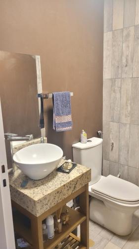 a bathroom with a sink and a toilet at Ombú Guests House in Puerto Iguazú