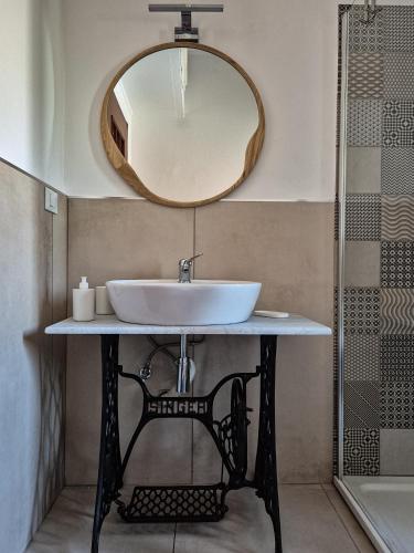 a bathroom with a sink and a mirror at Punto Zero Ca' Trillina in La Spezia