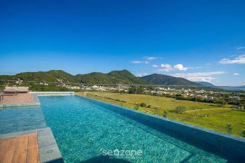 a swimming pool with a view of a city at Cozy Studios in Floripa - OKA in Florianópolis