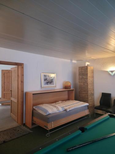 a bedroom with a bed and a pool table at Waldblick in Marlow