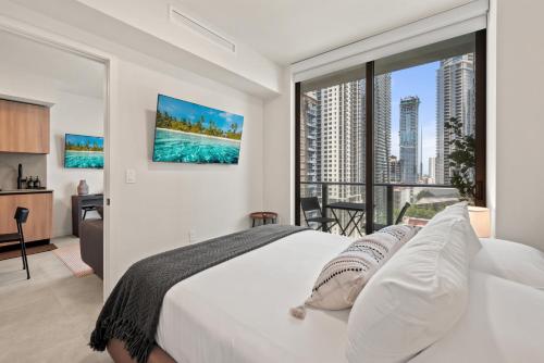 a bedroom with a white bed and a large window at 501 First Residences by Palermo Home Miami in Miami